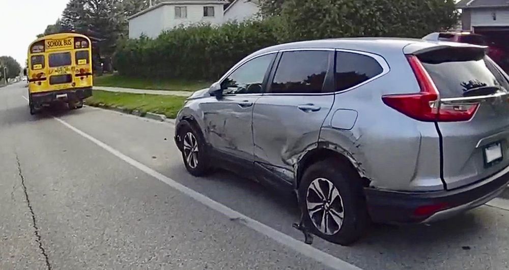 Driver charged after school bus full of students hits parked car post image