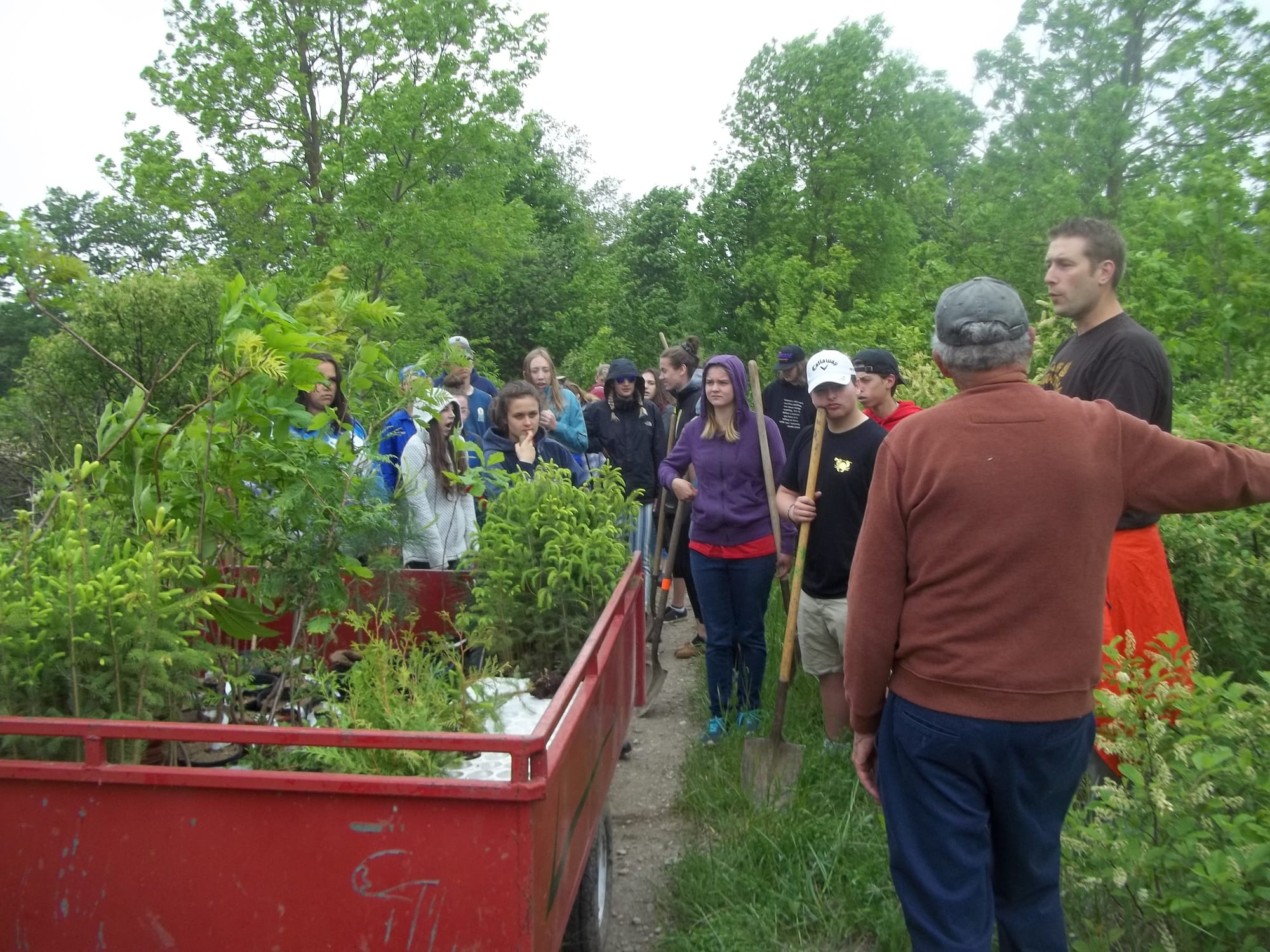 Wellington Heights students plant native trees along Arthur Trail