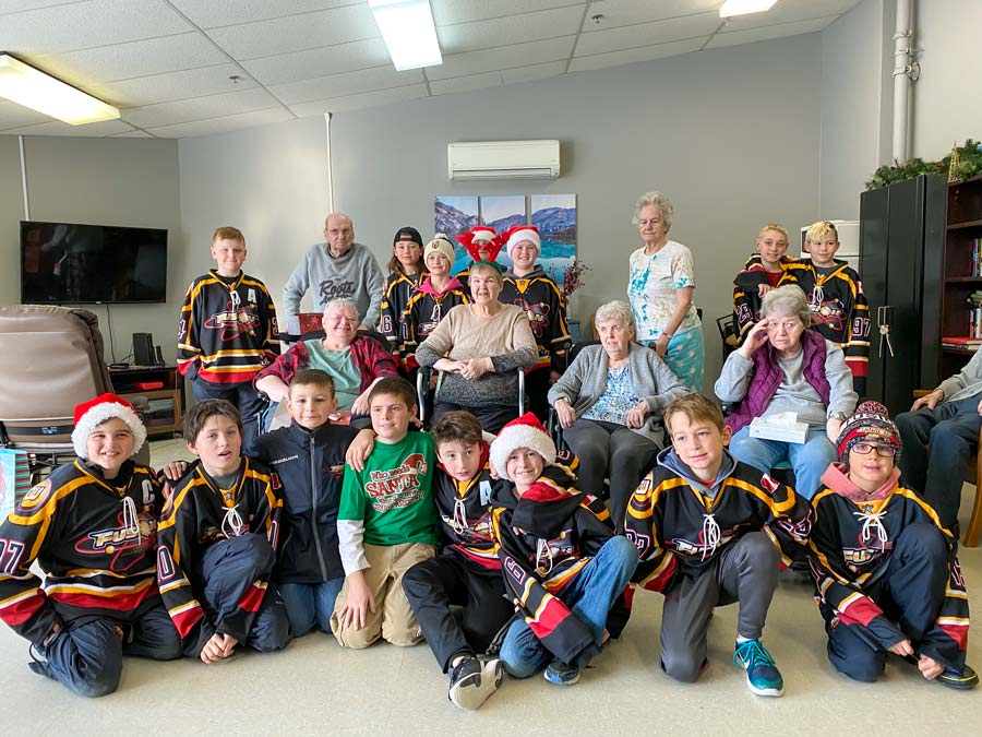 Local hockey players bring Christmas joy to Caressant Care residents