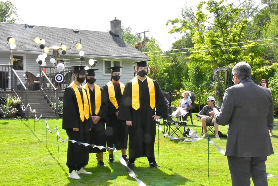 Family holds backyard graduation ceremony