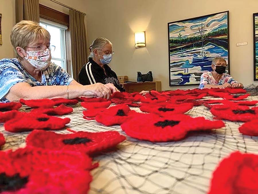 Volunteers craft poppies for Remembrance Day display