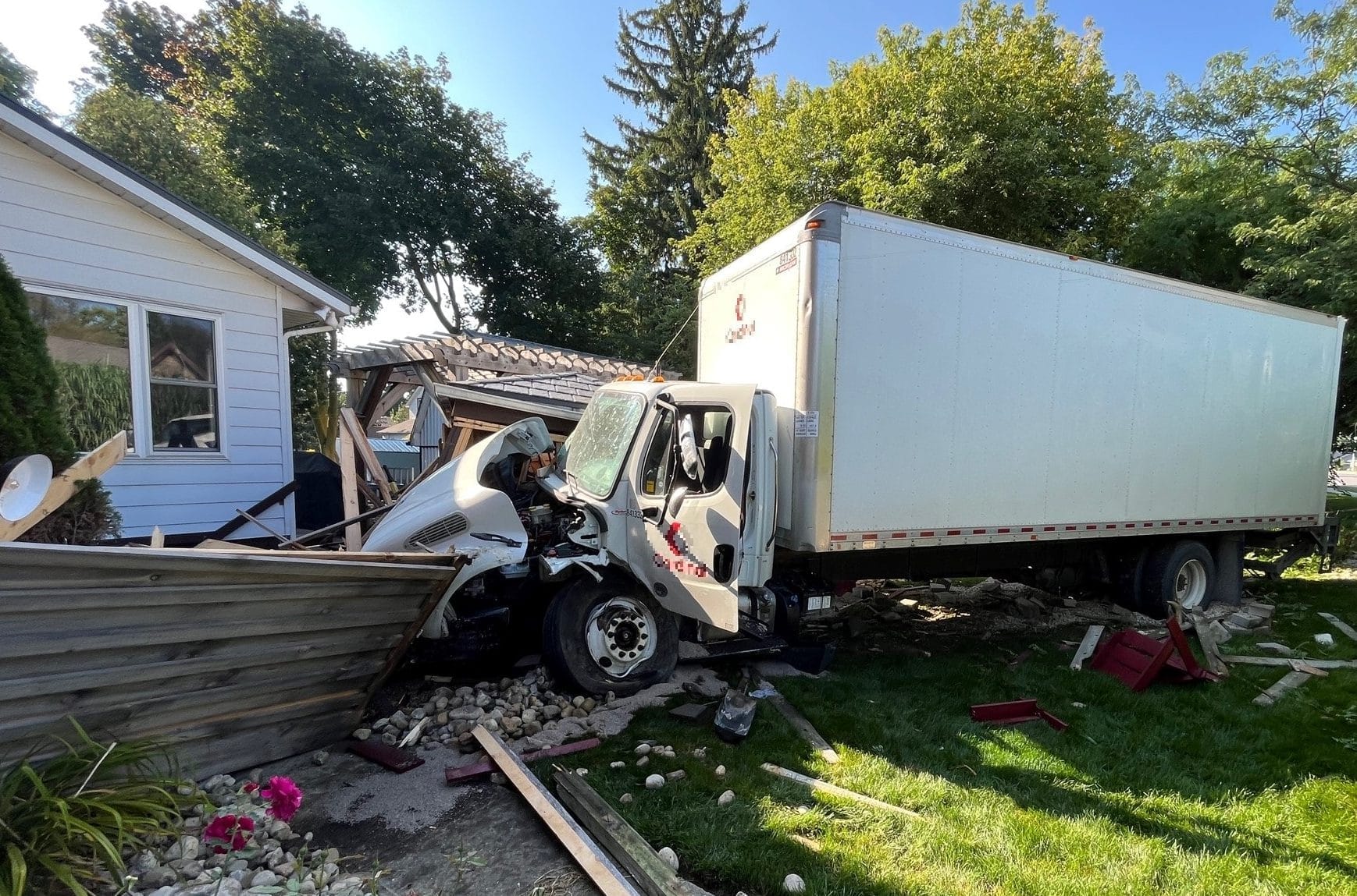 Truck crashes into fence, porch and shed, narrowly missing home