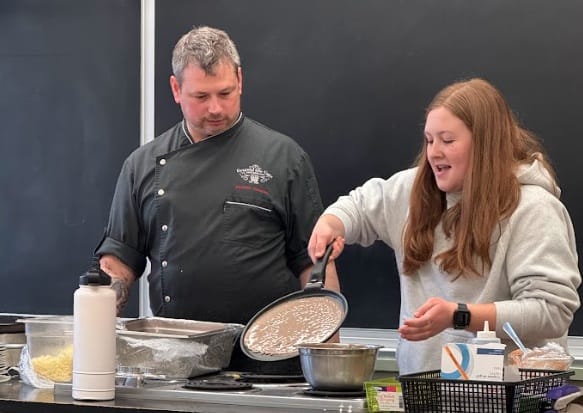 Chef Frederic Chartier teaches students how to cook