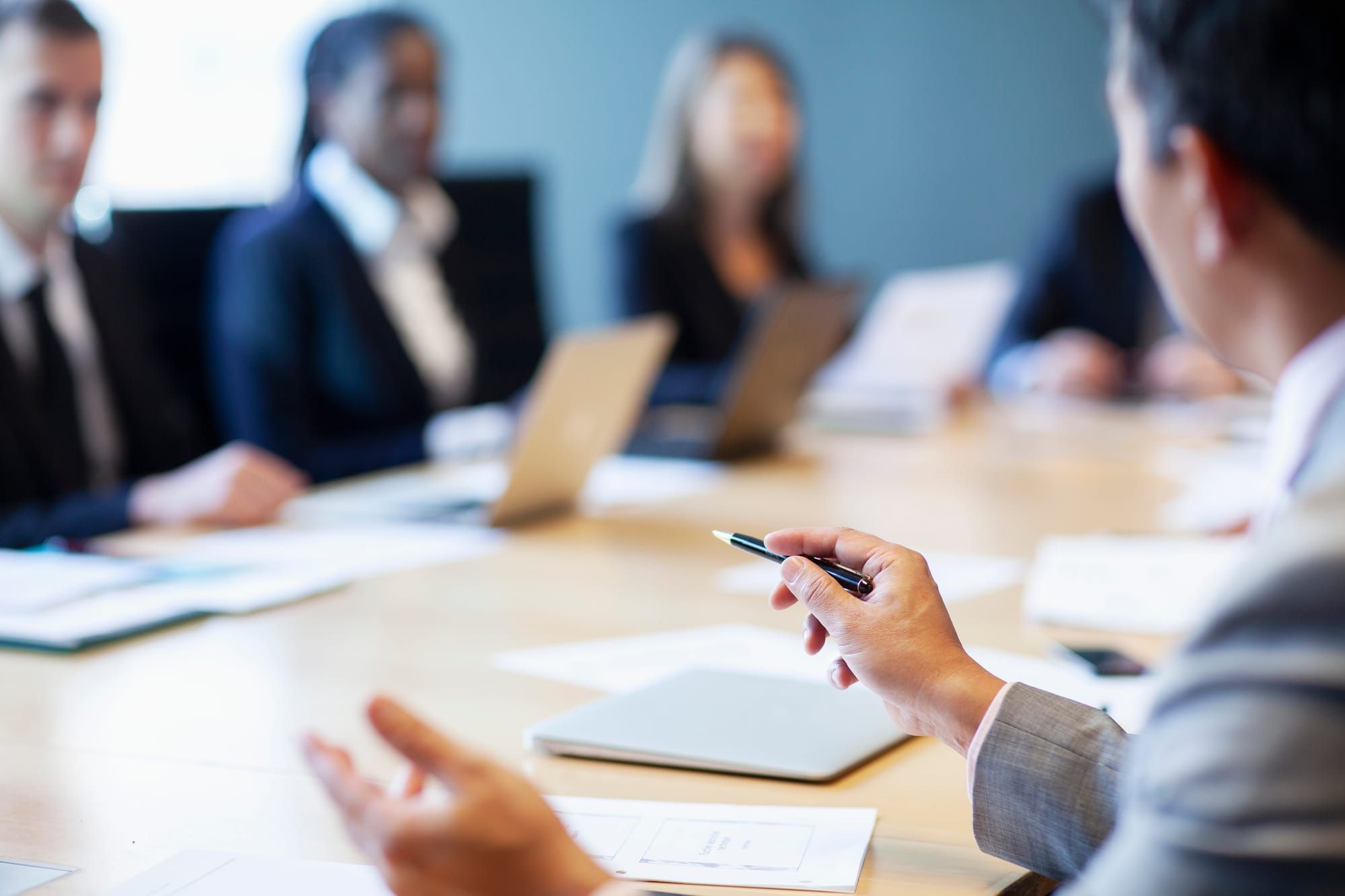 Business professionals negotiating across a conference table during an office lease discussion