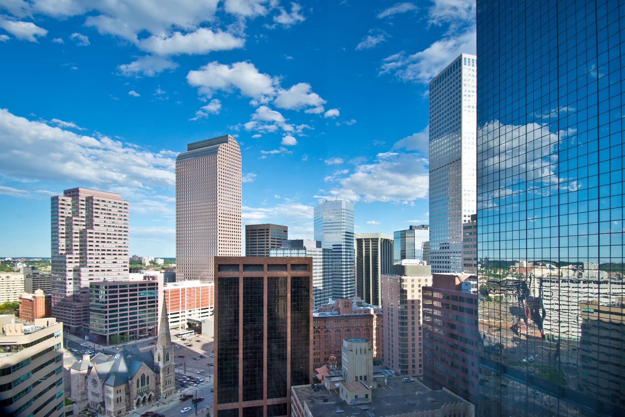 Downtown Denver skyline with glass office towers under a blue sky