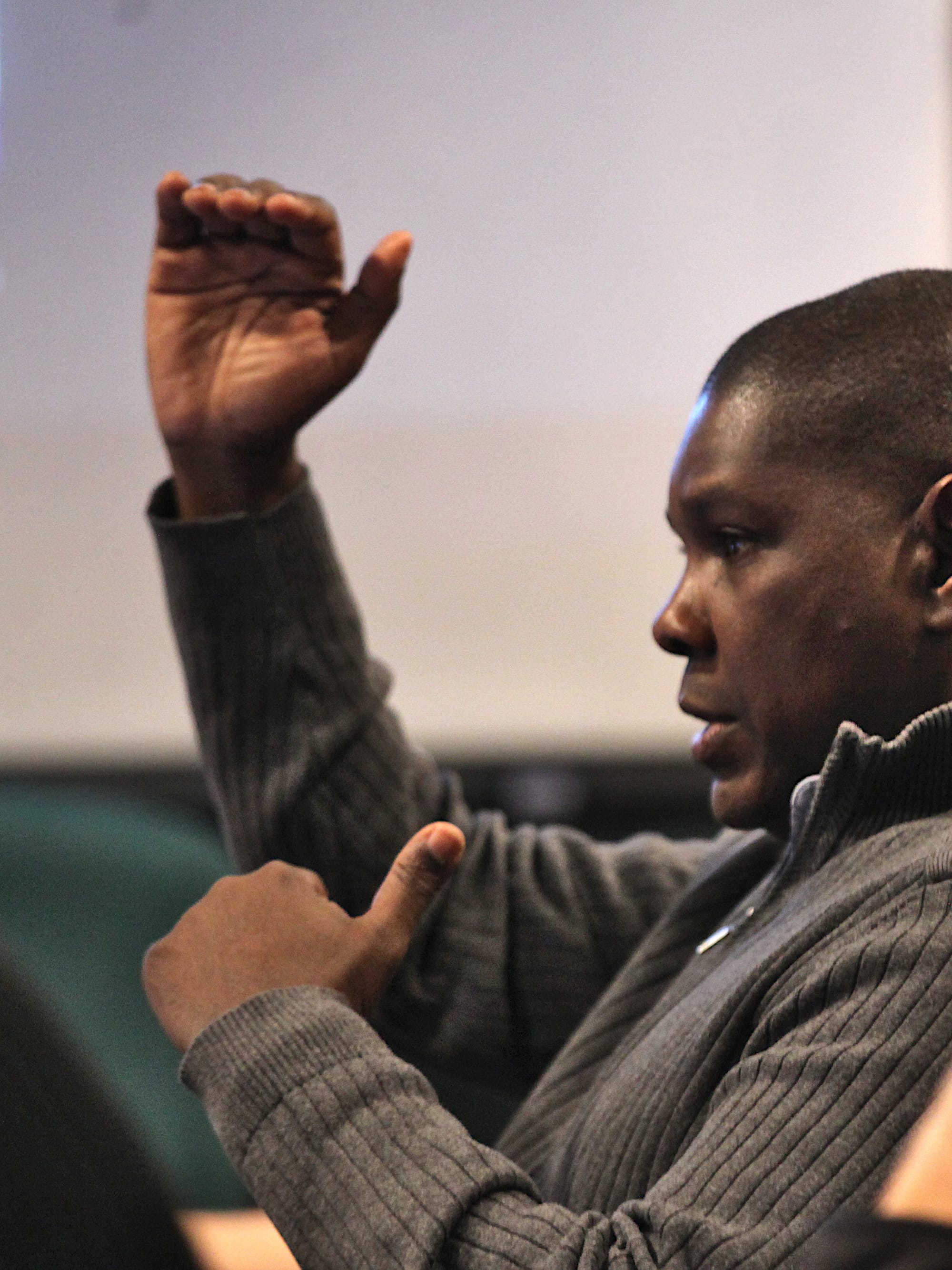 Photo of historic district commissioner Reynard Cross holding his hands out to show height