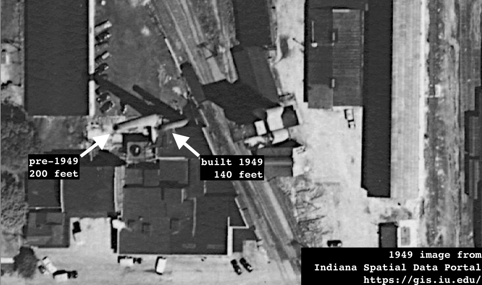 aerial photo from 1949 with arrows indicating a 200-foot smokestack that the current 140-foot smokestack, which is also shown in the photo
