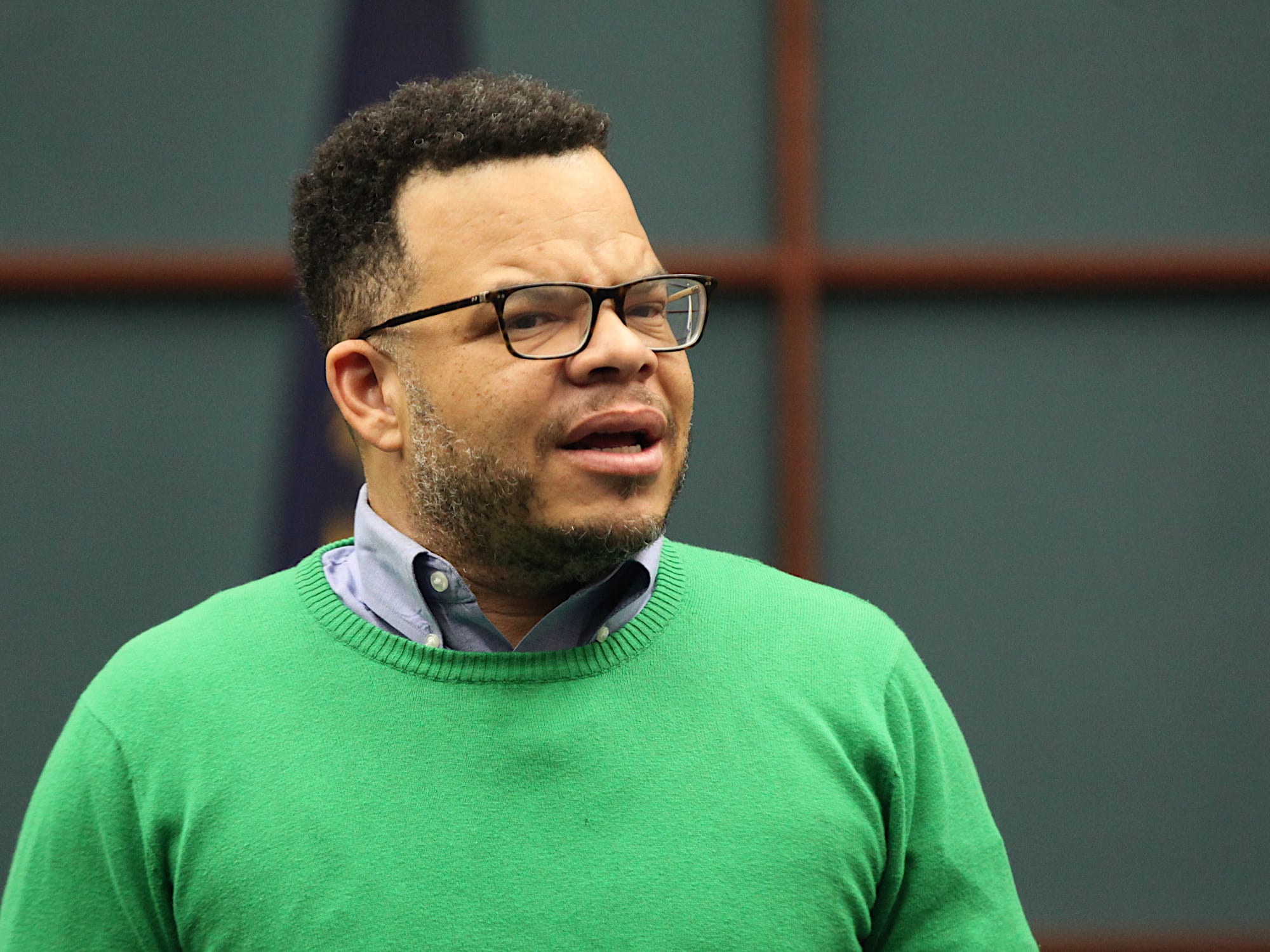 man standing in city council chambers