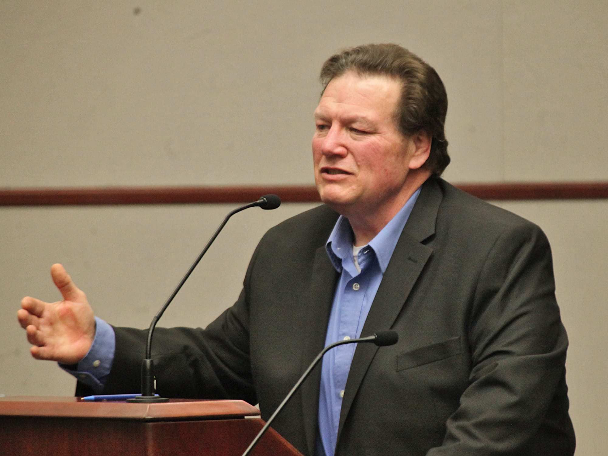 man standing at podium and mic