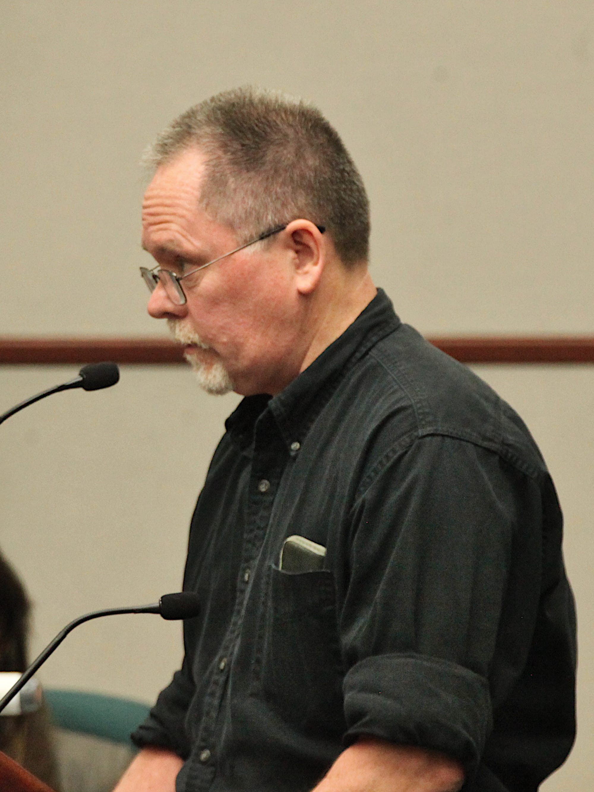 man standing at podium and mic