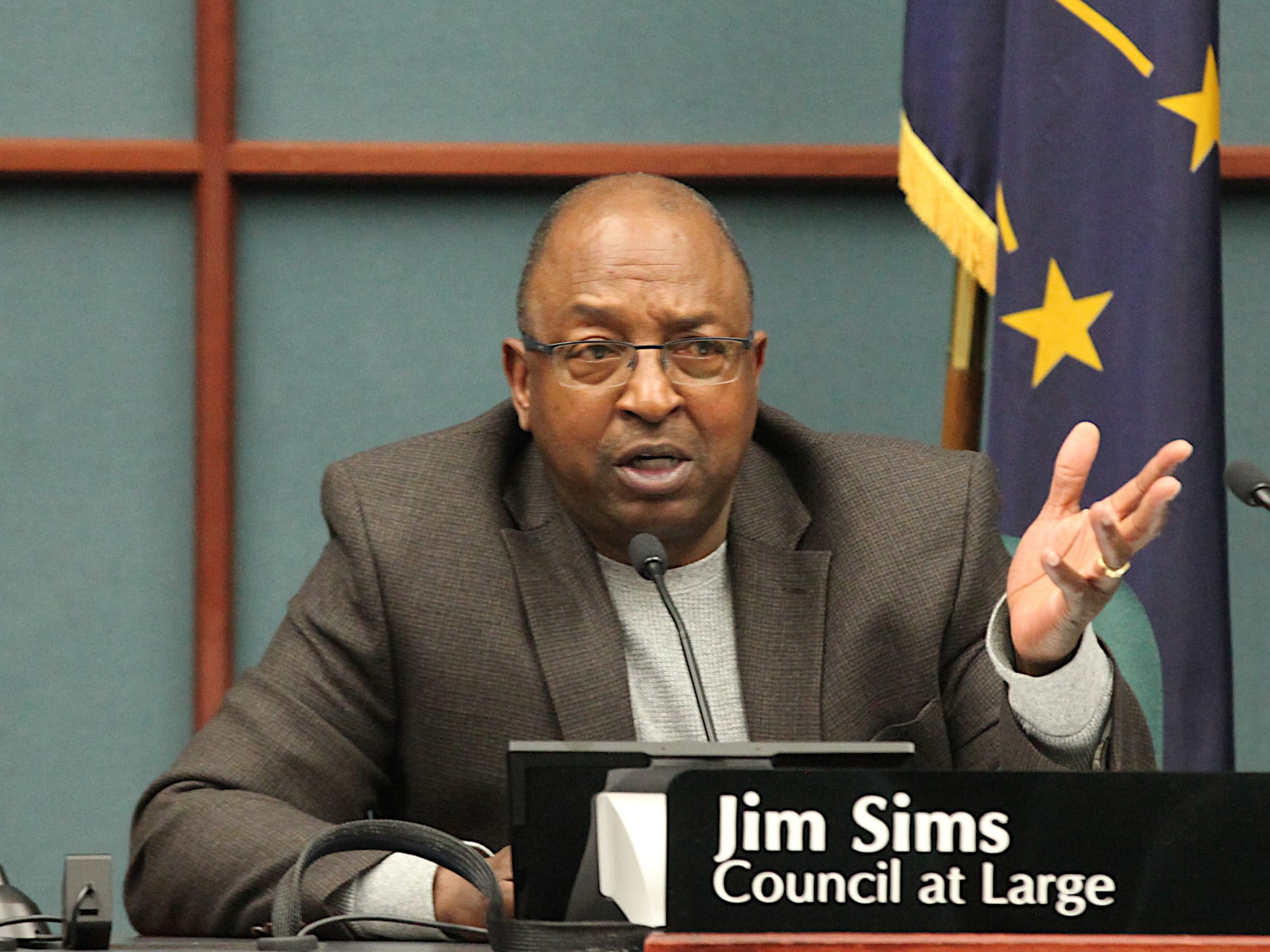man seated at city council dais