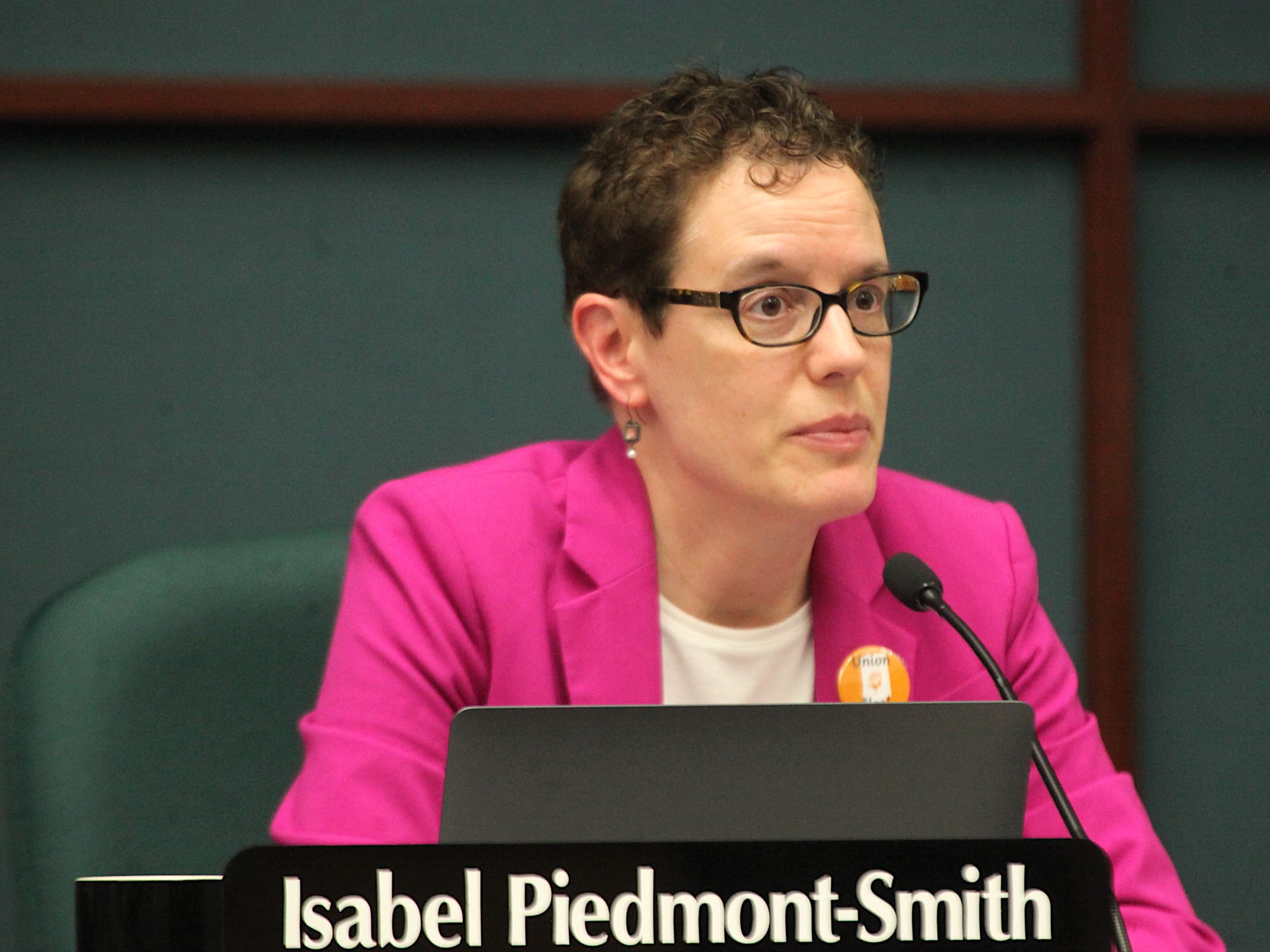 woman seated at city council dais