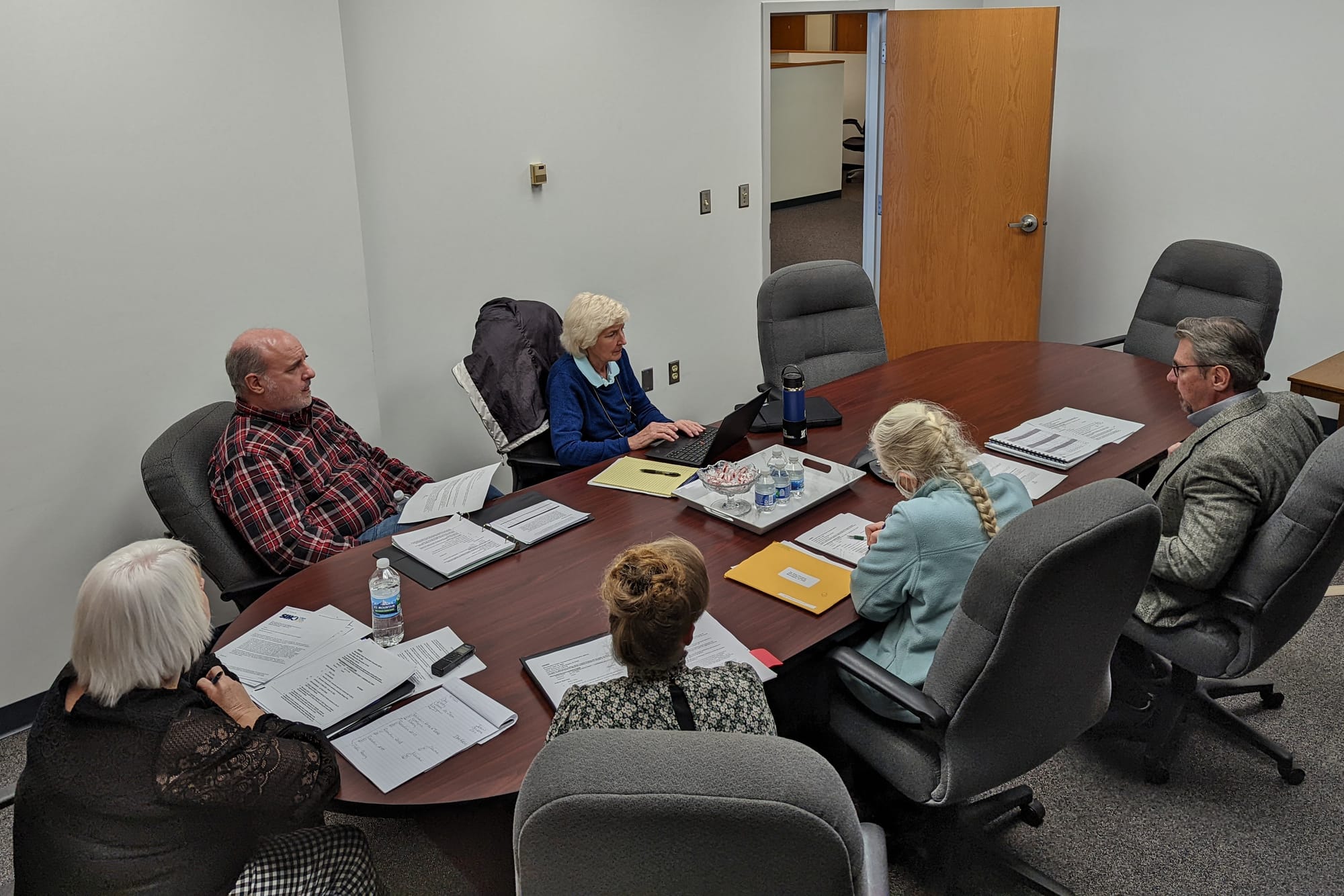 view of people sitting around a conference room table