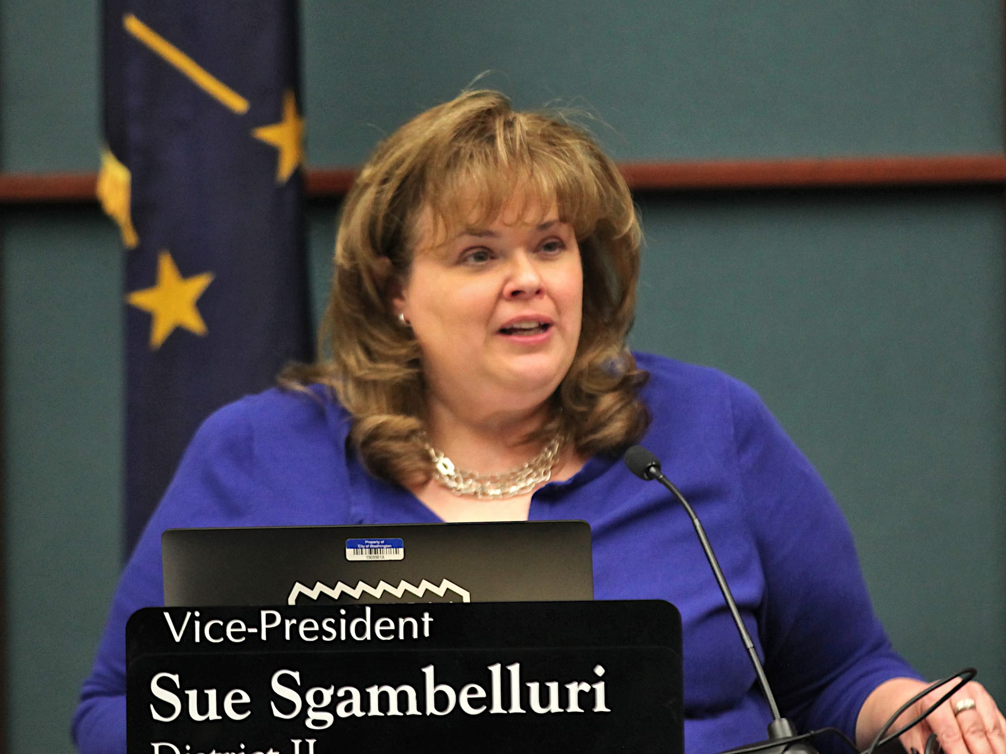 woman seated at council dais