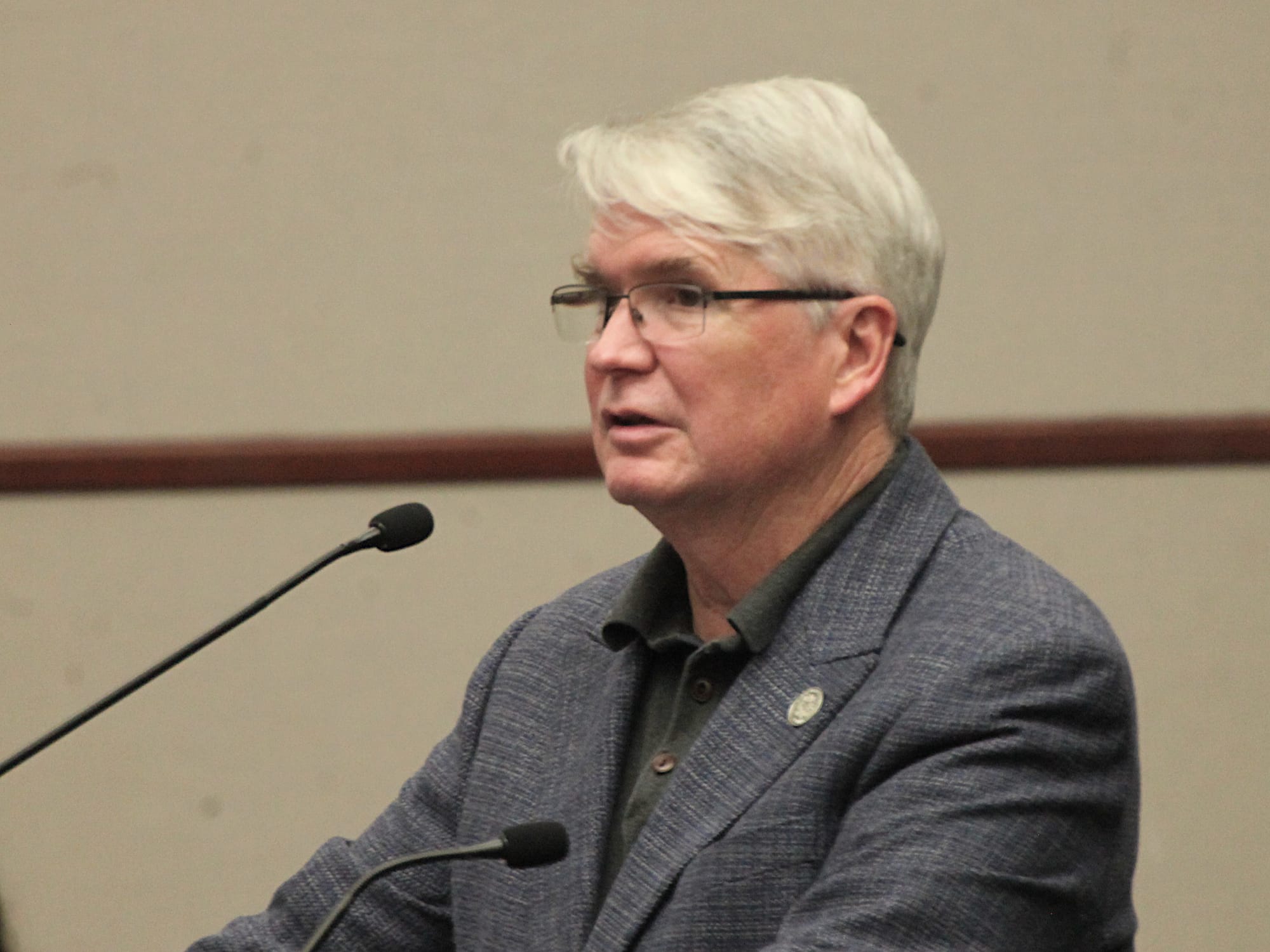 man standing at podium and mic
