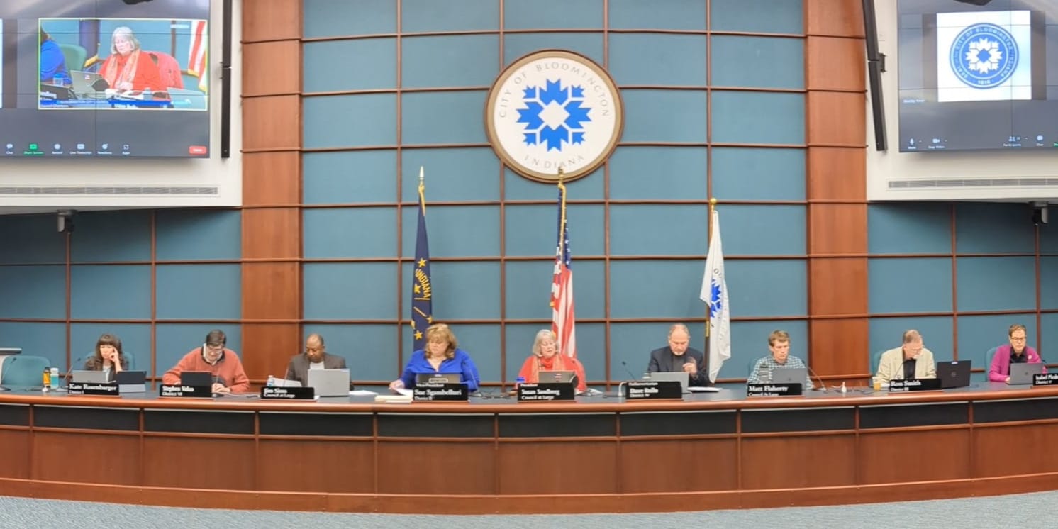 9 city councilmembers seated at the dais