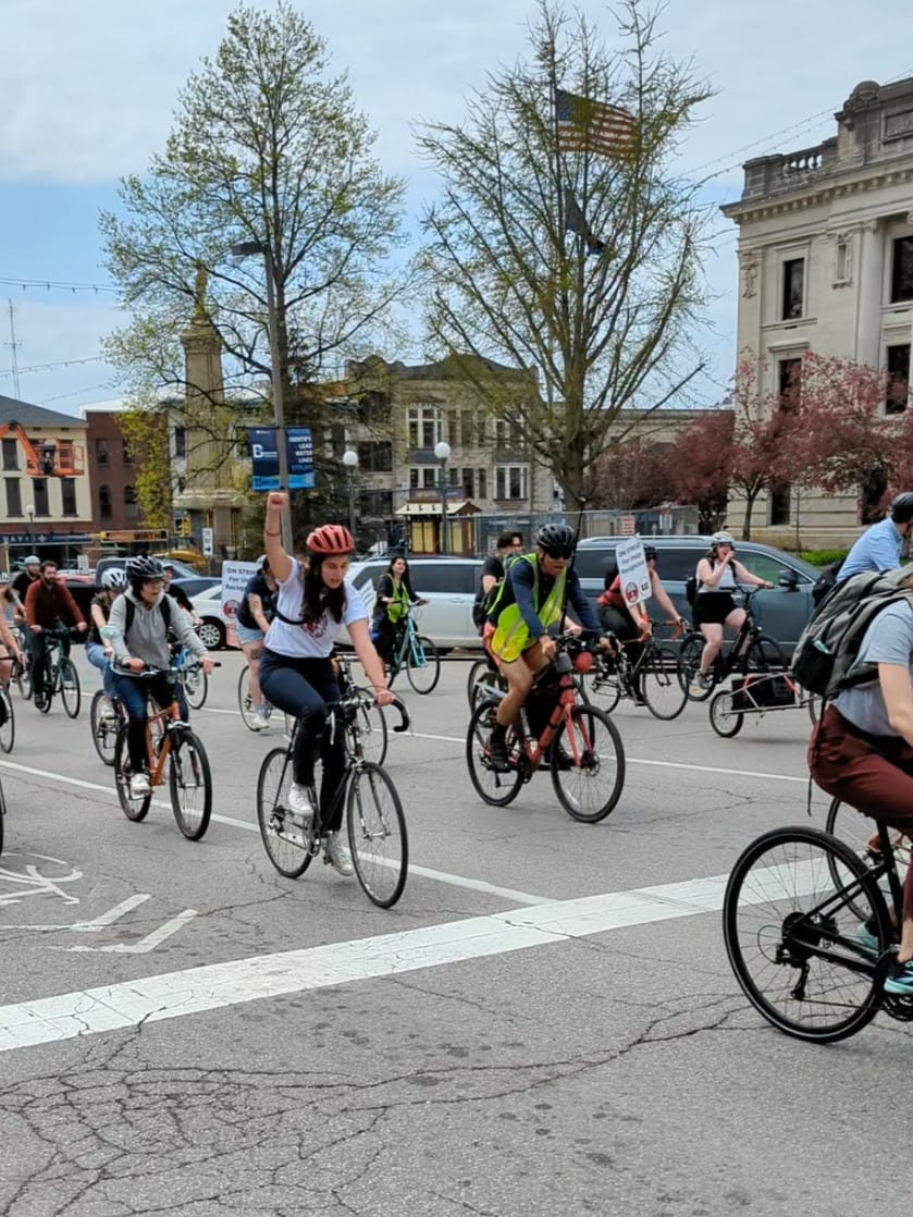 bicyclists riding from left to ride with signs that read "ON STRIKE for union recognition"
