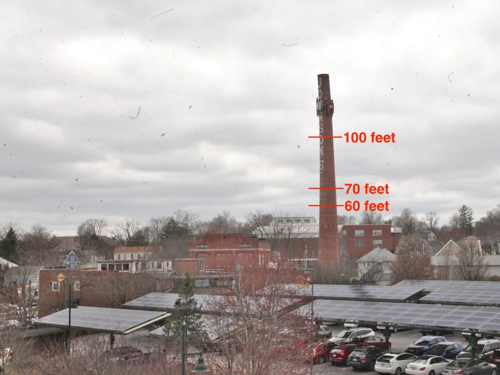 photo of skyscape with Johnson's creamery smokestack and heights marked on the stack