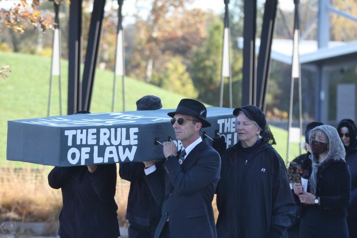 Dirge for democracy: Bloomington protesters stage mock funeral at Switchyard Park