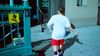 Closeup of a boy approaching the 96th Street New York City subway entrance from the sidewalk.