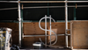 A dollar sign bike rack, designed by David Byrne, surrounded by scaffolding and construction material on Wall Street near the New York Stock Exchange