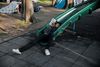 A child reads a book while lying on a green slide at a playground