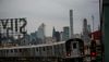 Subway train approaching with Manhattan skyline in the background