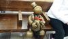 Toy person sits on a subway bench 