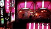 Night scene of Restaurant Almond at Roppongi Corner in Tokyo, lit in pink.
