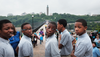 Five teenage boys who are members of the Highland Voices boys choir pause as pedestrians walk over the High Bridge, which connects Manhattan to the Bronx