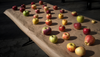 Different varieties of apples laid out on a table at a farmer's market