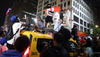 Rowdy Knicks fans atop a taxi cab.