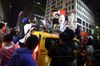 Rowdy Knicks fans atop a taxi cab.