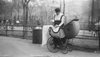 Woman with Baby Carriage Holding Milk Bottles from Depot set up by merchant Nathan Straus that Provides Pasteurized Milk to Poor Families