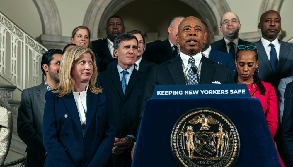 Mayor Eric Adams of New York City introuces Sanitation Commissioner Jessica Tisch, standing next to the lectern, as his choice for police commissioner at CIty Hall