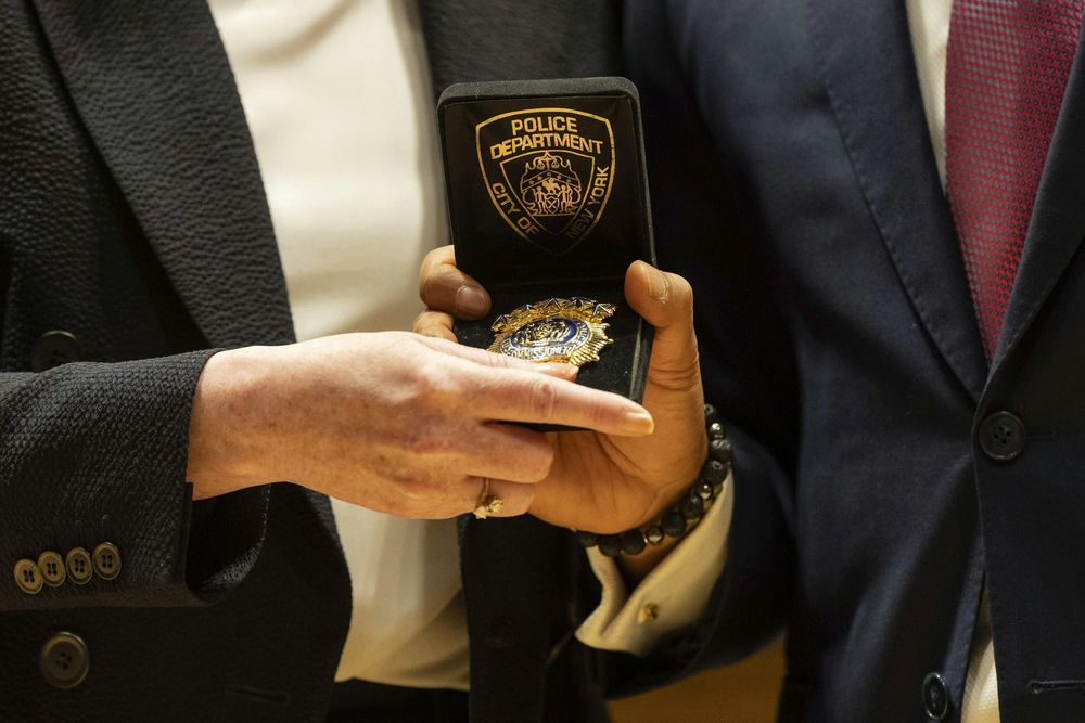 NYPD Commissioner Jessica Tisch handed a badge from Mayor Eric Adams
