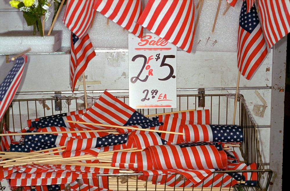A bin of miniature American flags on a 2 for $5 sale