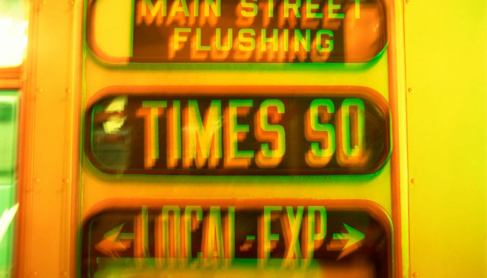 Blurry image of subway sign TIMES SQ