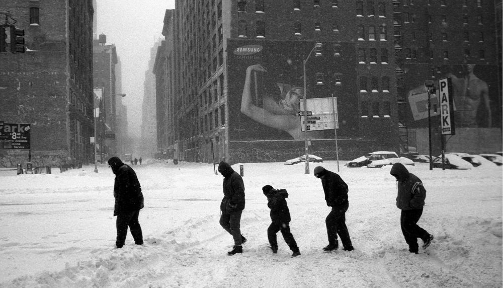 New Yorkers walk through streets in deep snow