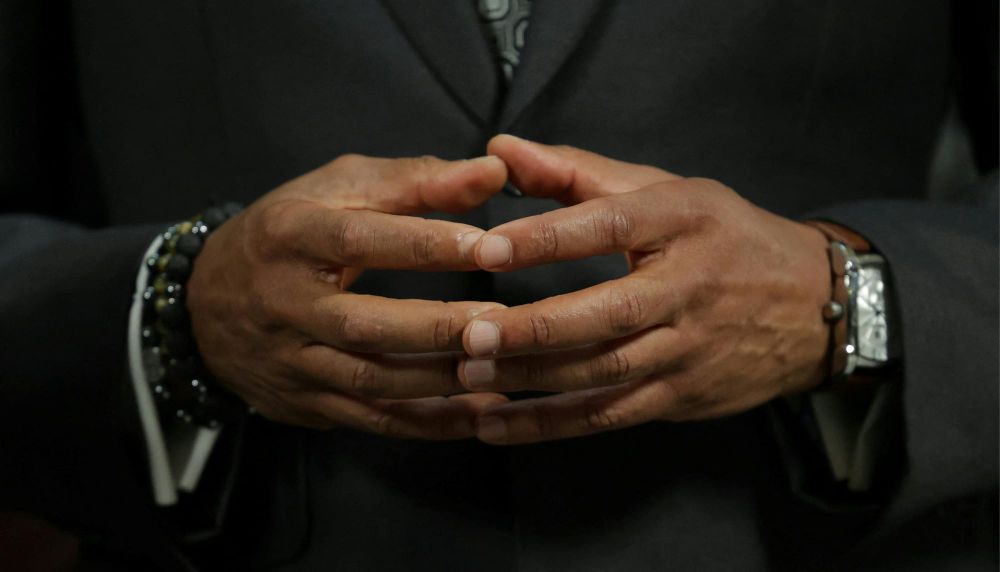 Close up image of Mayor Adams' hands with fingers touching 