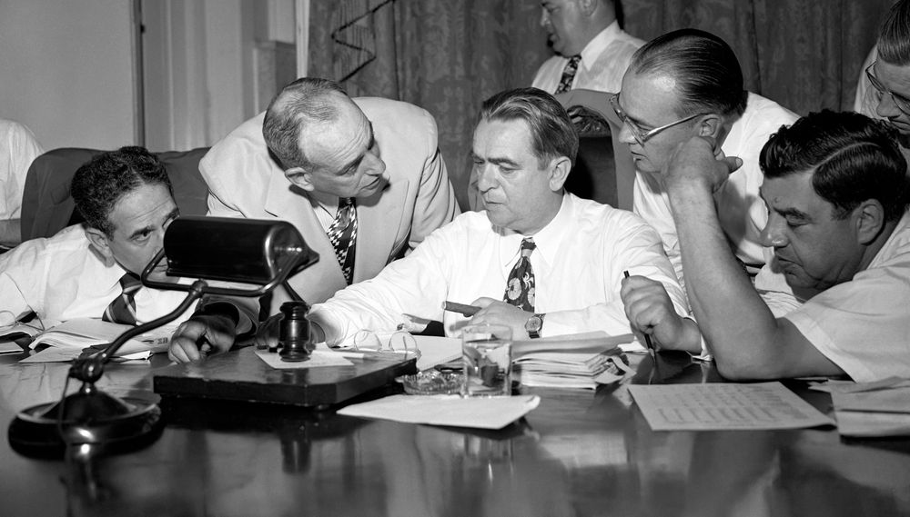 Vincent R. Impellitteri, Robert Moses, William O'Dwyer, John Cashmore and Lazarus Joseph talk in a group huddle during the Board of Estimate Hearing