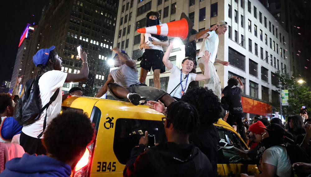 Rowdy Knicks fans atop a taxi cab.