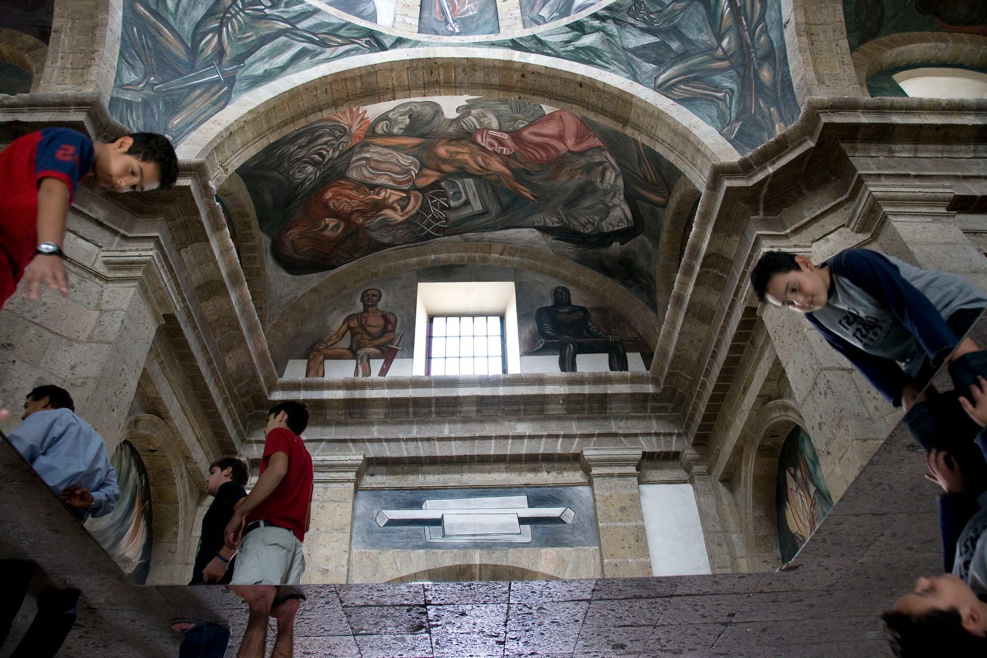 Children look at the murals in the Las Cabanas museum in Guadalajar