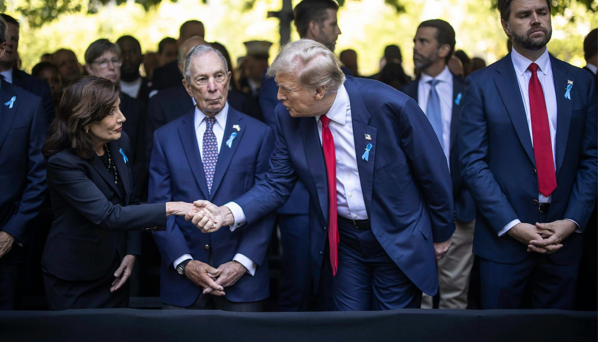 New York Gov. Kathy Hochul shakes hands with former President Donald Trump at a ceremony