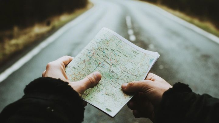 Image of two hands holding a road map