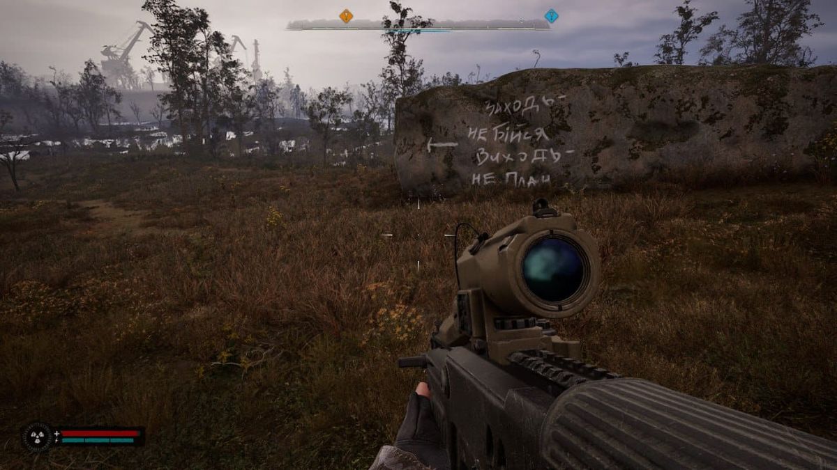 Stalker in the swamps, with a part of a wall that has a text painted on it: Come on in - don't be afraid, but once you leave - don't cry