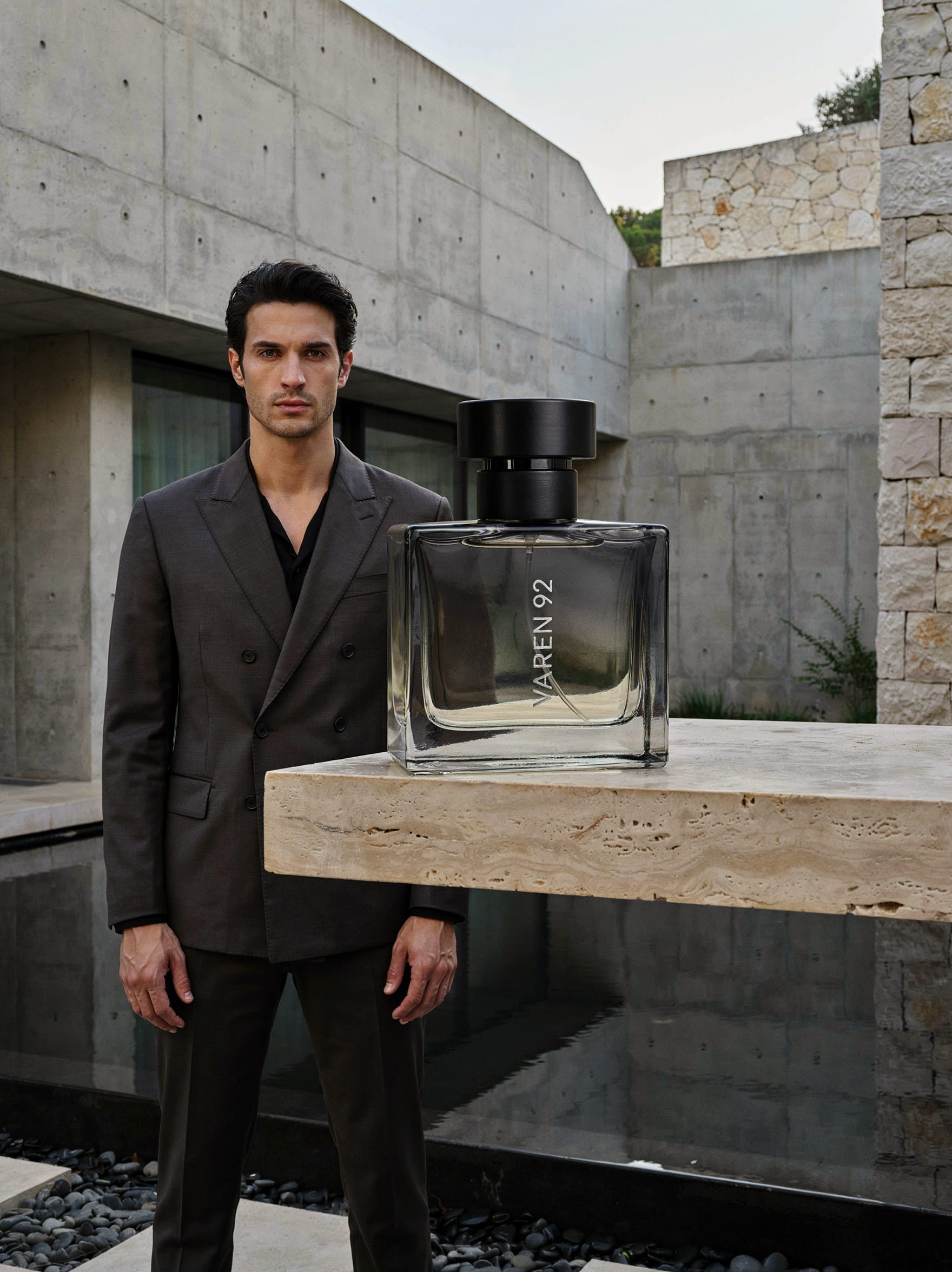 Ideogram 4.0 fragrance campaign showing a distant suited man behind a large foreground VAREN 92 bottle in a concrete villa.