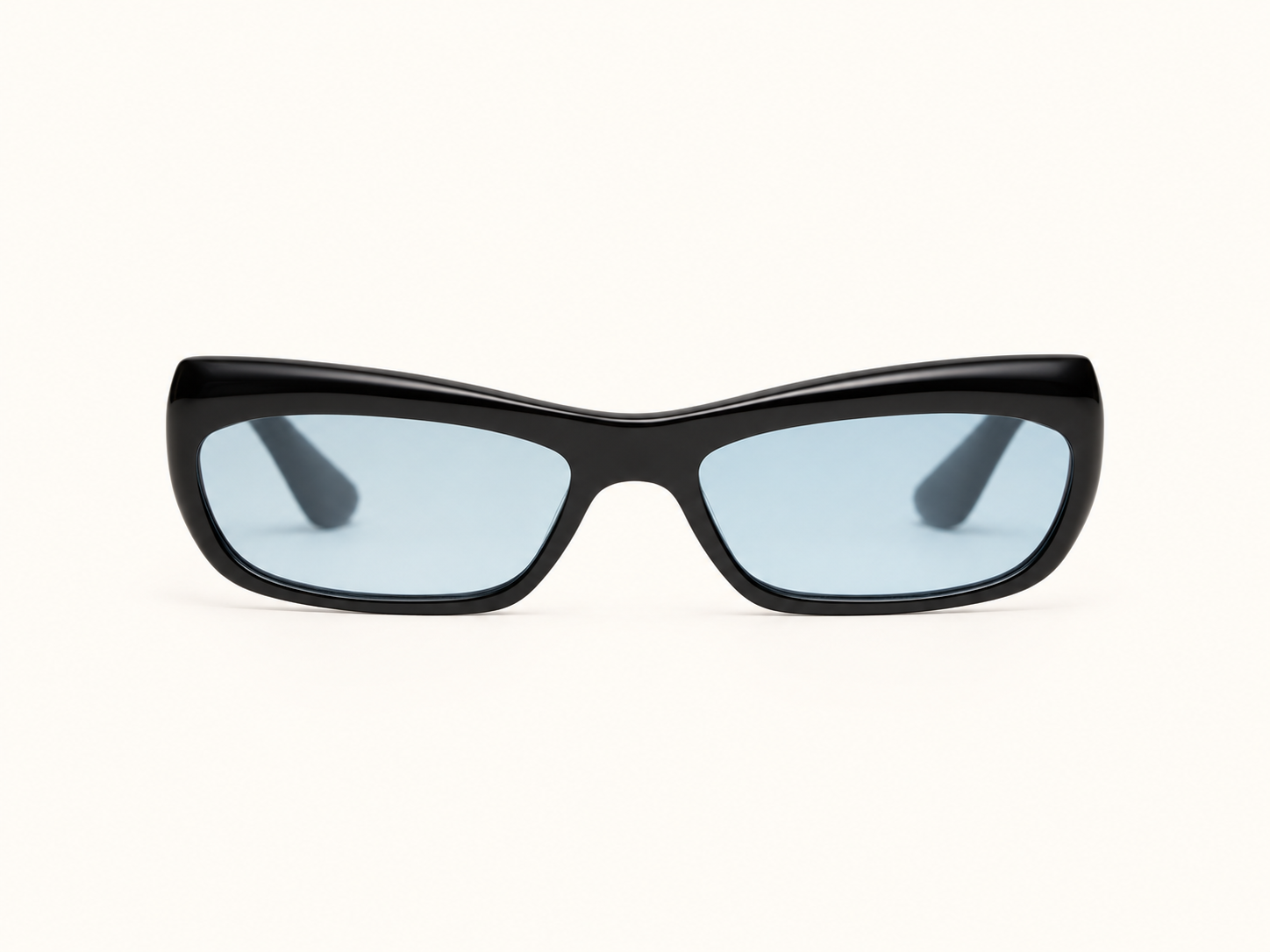 Black angular sunglasses with pale blue lenses, shown front-on against a warm ivory background.