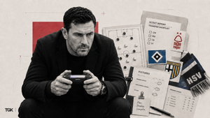 Football manager holding a controller beside scouting reports, tactical notes and club badges.