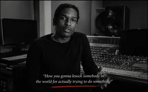 A$AP Rocky speaks in a recording studio alongside a quote about not being afraid to try.